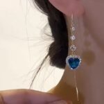 New style fashionable imitation blue crystal earrings, heart-shaped diamond-encrusted ear wires, women's long heart-shaped pendant ear wires with a sense of luxury.